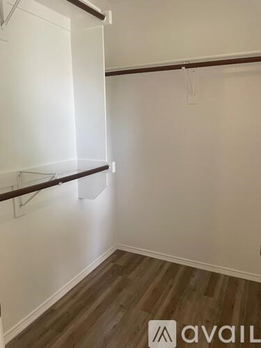 A room with a white wall and a wooden floor.