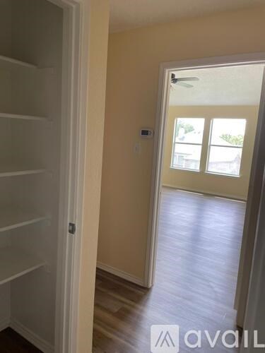 A hallway with a door and a window.