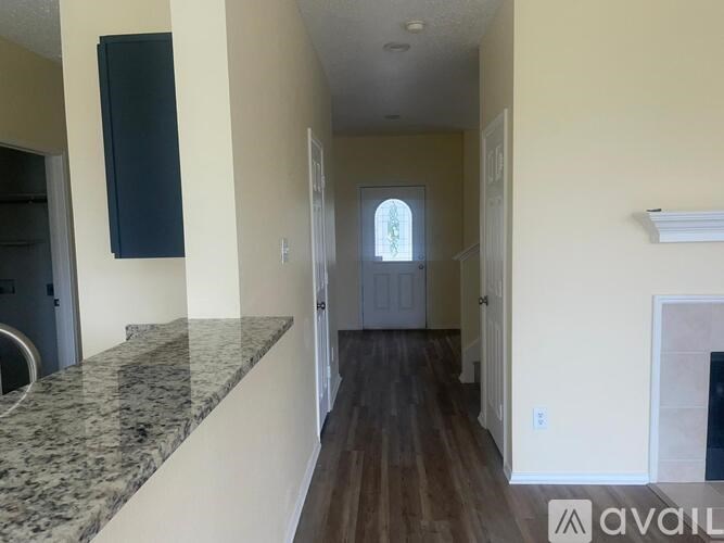 A room with a marble countertop and wooden flooring.