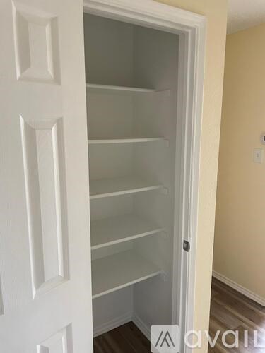 A white door with a glass panel is open.