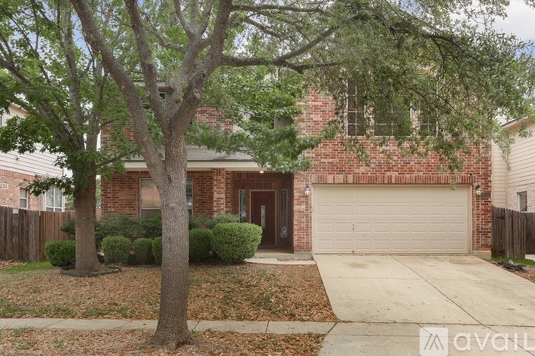 A house with a brown brick exterior and a white garage door.