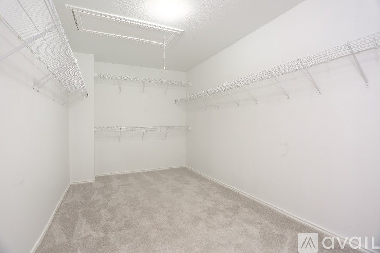 Empty room with white walls and carpeted floor.