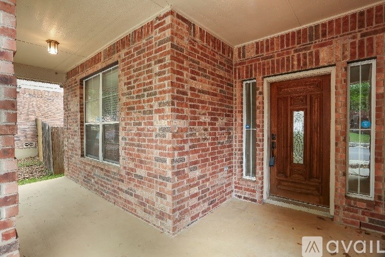 A red brick house with a brown door and windows.
