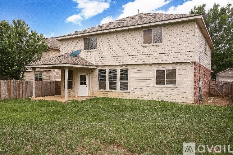 A house with a white siding and a brown roof is for sale.