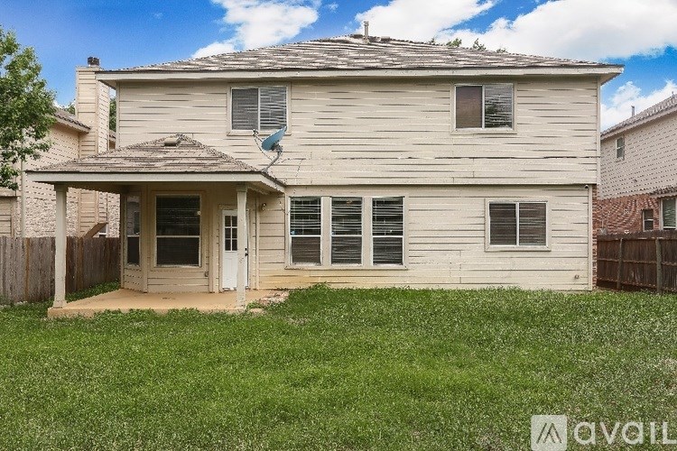 A house with a brown roof and a white door is for sale.