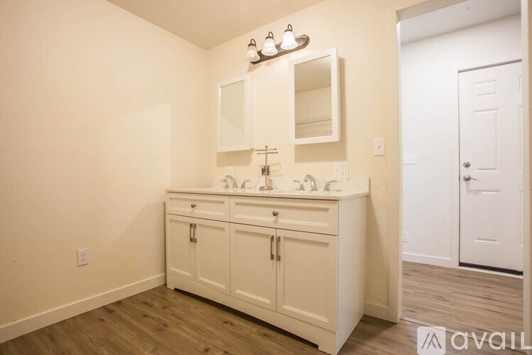 A bathroom with a vanity and a mirror.