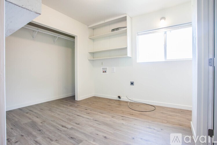 A room with a white wall and a window.