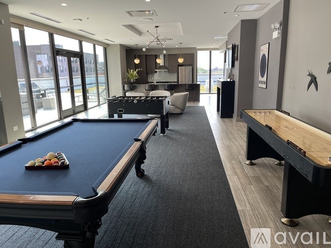 A pool table with balls and a cue stick on it.