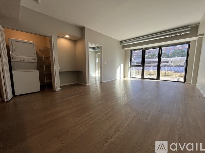 A room with a door leading to a balcony.