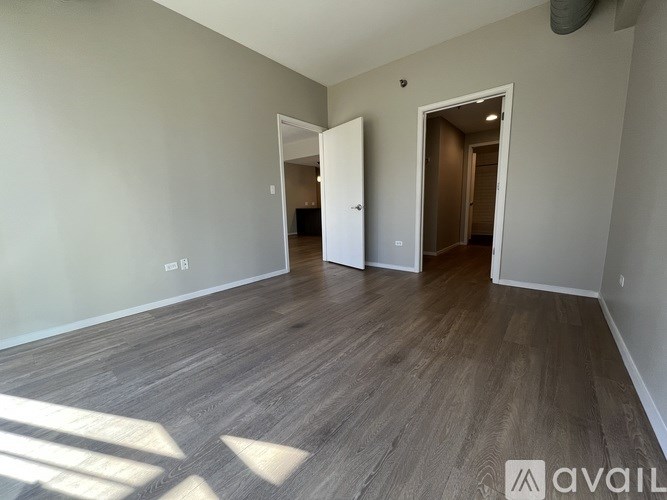 A kitchen with a black countertop and brown cabinets.