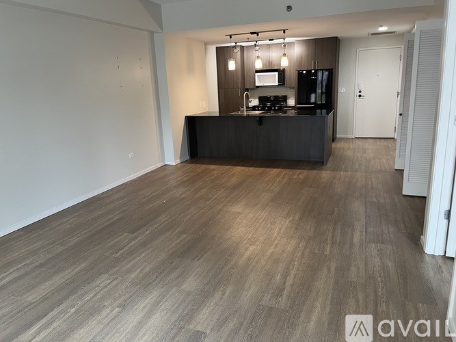 A kitchen area with a counter and cabinets.