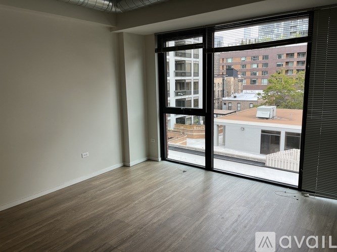 A room with a large window overlooking a cityscape.