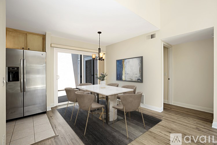 A modern kitchen with a dining table set for four.