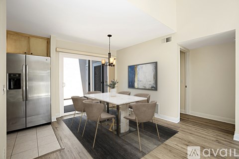 A modern kitchen with a dining table set for four.