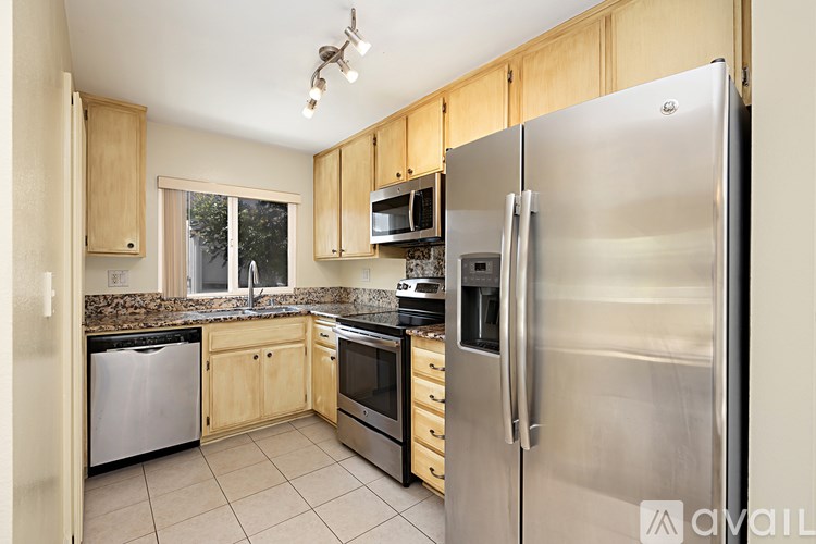 A kitchen with wooden cabinets and stainless steel appliances.