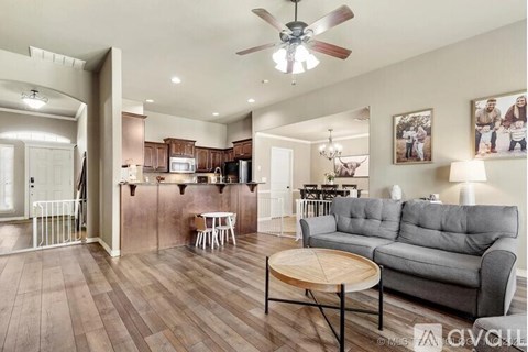 A living room with a grey sofa and a wooden coffee table.