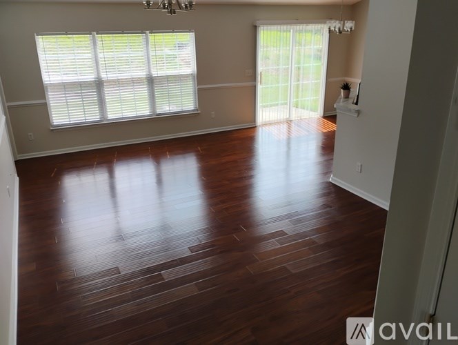 A room with wooden floors and a chandelier.