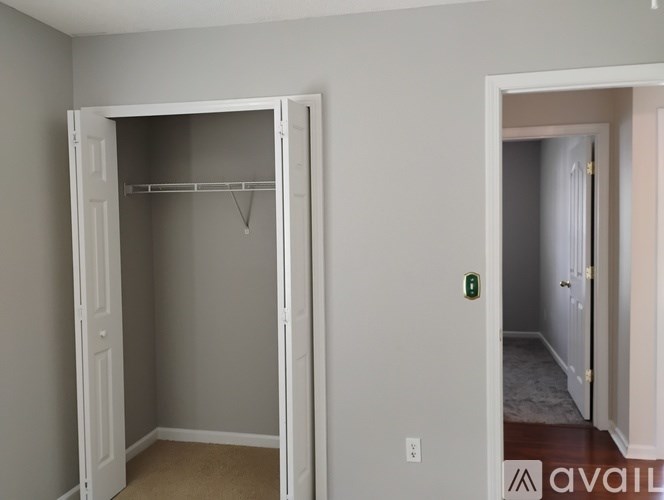 A white closet with a hanger is in the middle of a room.