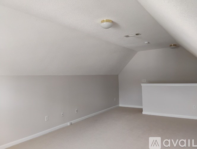 A room with white walls and carpeted floor.