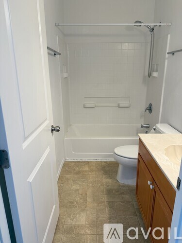 A bathroom with a toilet, sink, and bathtub.