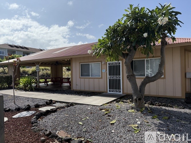 A house with a tree in front of it.