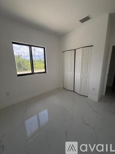 A room with a large window and a sliding door.