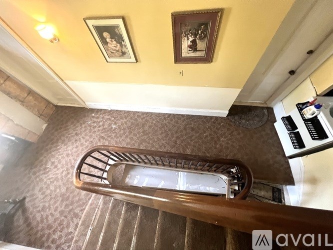 A staircase with a metal railing and a carpeted runner.