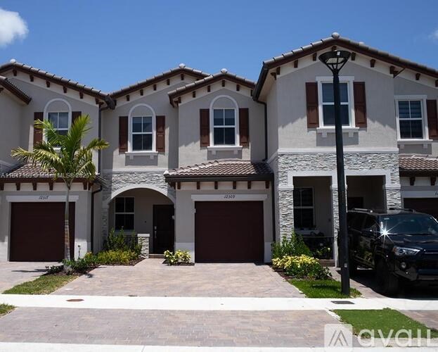 A house with a black car parked in front.