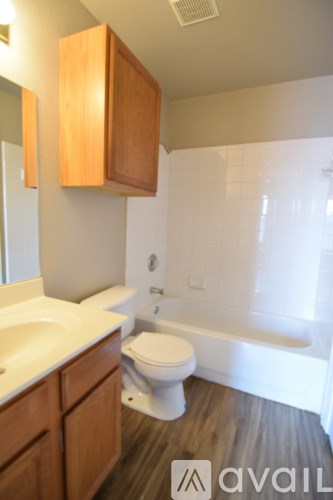 A bathroom with a toilet, sink, and tub.