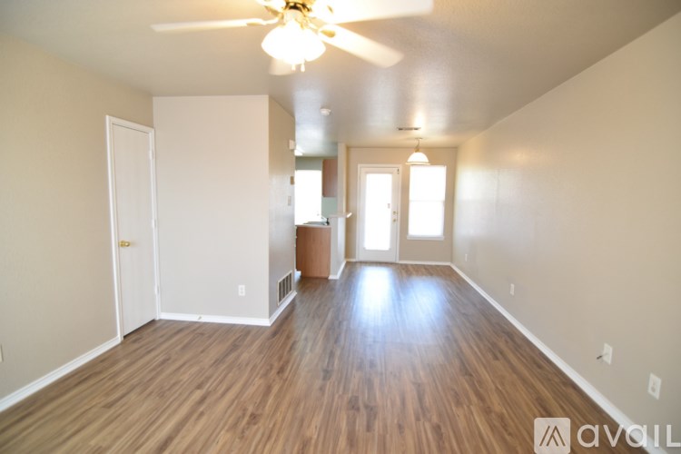 A room with wooden floors and a ceiling fan.