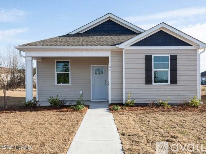 A small house with a white door and two windows.