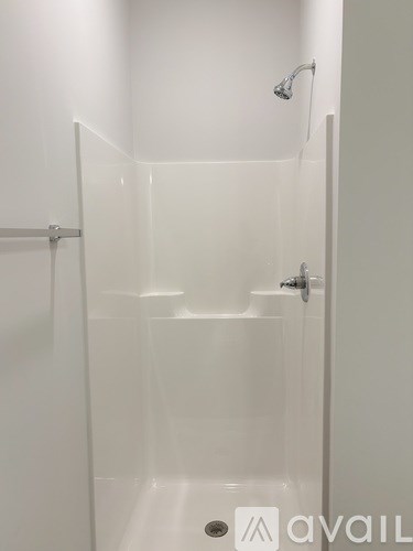 A white bathroom with a glass shower door.