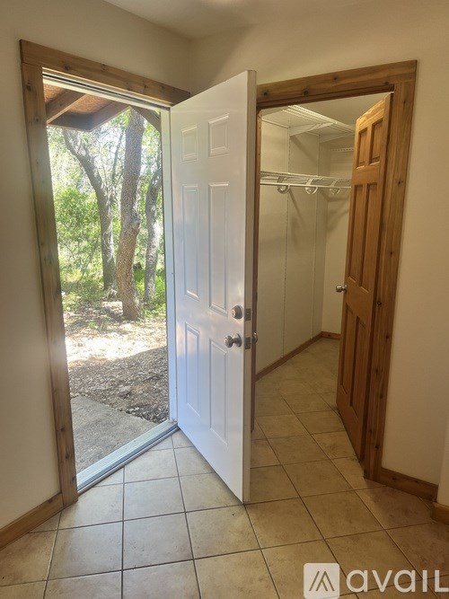 A room with a white door and a wooden door frame.