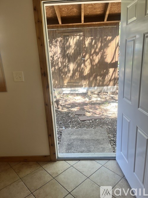 A view from inside a house looking out to a backyard.