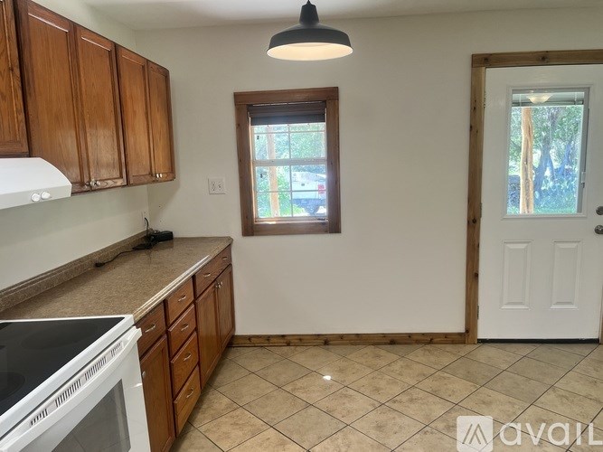 A kitchen with wooden cabinets and a white oven.
