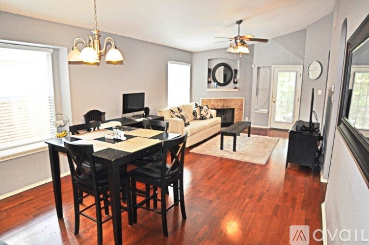 A dining room with a table and chairs.