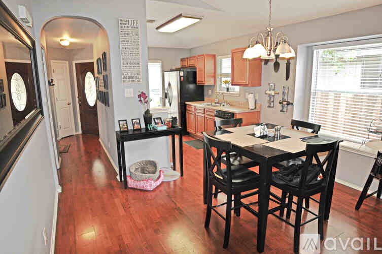 A kitchen with a table and chairs in the middle of the room.
