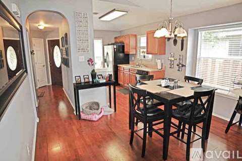 A kitchen with a table and chairs in the middle of the room.