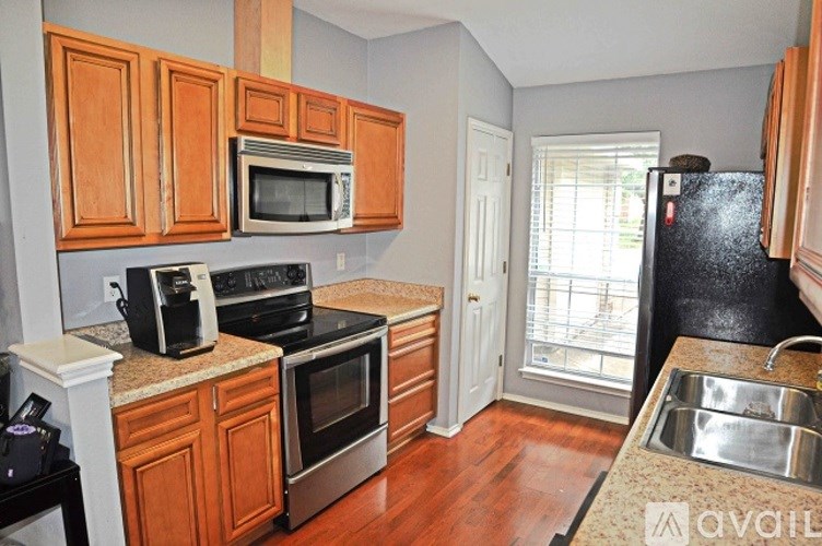 A kitchen with wooden cabinets and stainless steel appliances.