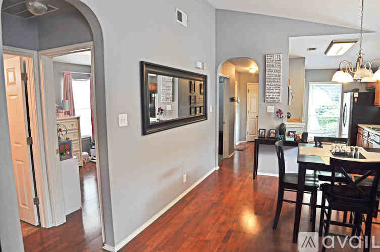 A kitchen with a dining table and chairs.