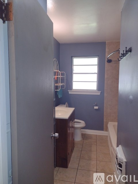 A bathroom with a toilet, sink, and shower.