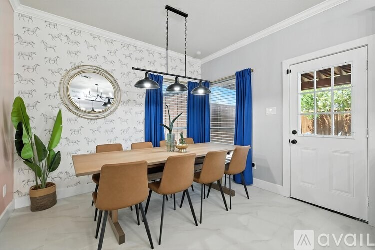 A dining room with a table set for six.