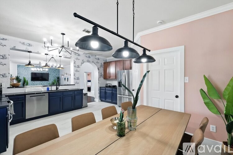 A kitchen with blue cabinets and a wooden table.