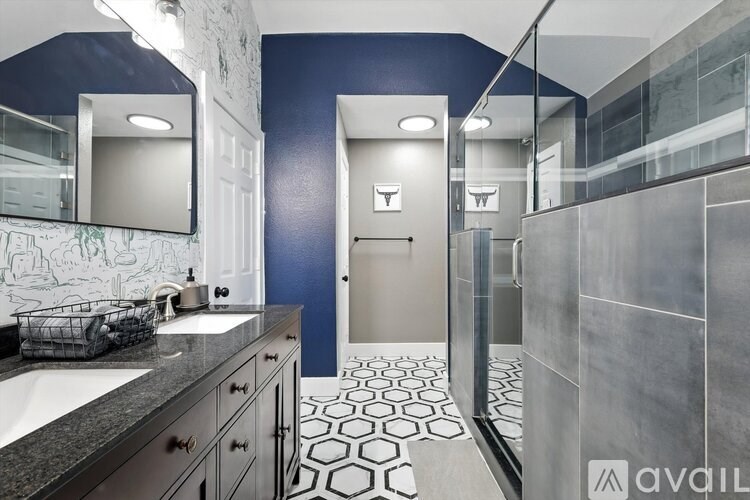 A bathroom with a blue wall and a white door.