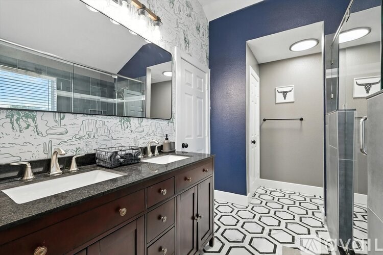 A bathroom with a blue wall and a white sink.