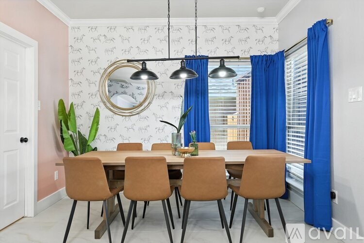 A dining room with a table set for six and a mirror on the wall.