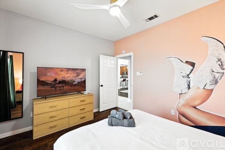 A room with a bunk bed, desk, and chair.