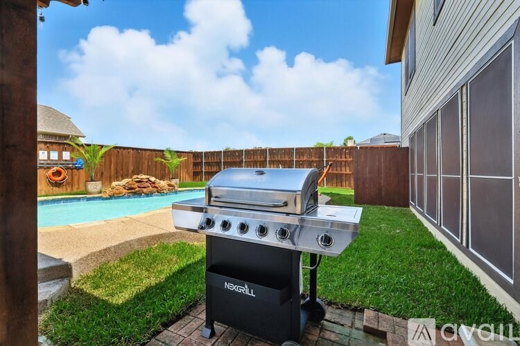 A NexGill grill is on a patio next to a pool.