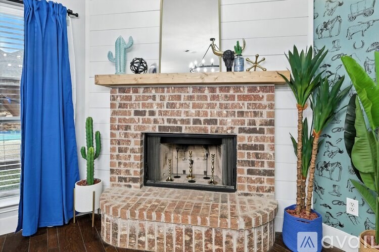A modern living room with a grey sofa, a bar area, and a large chandelier.