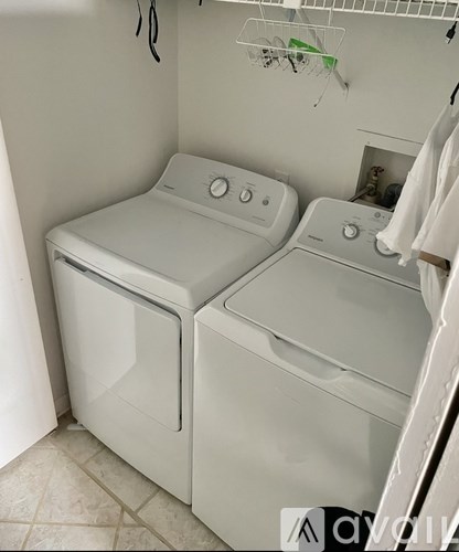 A small laundry room with a washer and dryer.